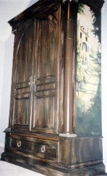 Pine armoire with layers of paint, distressed, aged and hand painted murals on the side panels